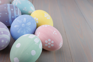 Fototapeta na wymiar Easter painted eggs on wooden light background