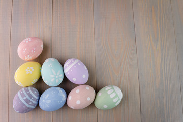 Easter painted eggs on wooden light background. Empty space for text.