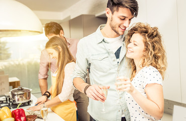 Group of friends cooking at home to have dinner together