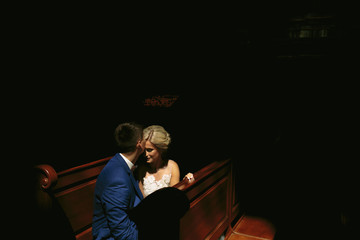 bride and groom illuminated by light