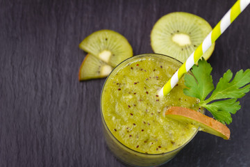Green fresh healthy smoothie with kiwi and parsley