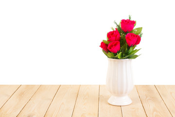 Red roses in pot on wood texture isolated on white background