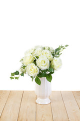 White roses in pot on wood texture for background.