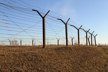 The perimeter is surrounded by barbed wire. Strangers here do no
