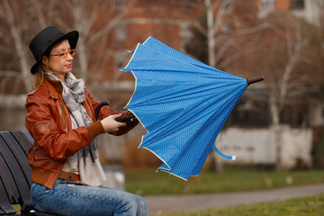 Lady opening blue umbrella