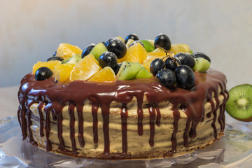 sponge cake is decorated with fruits and chocolate stains