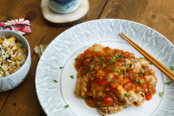 Sweet and sour chicken with rice on a plate
