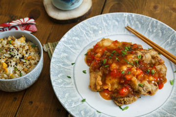 Sweet and sour chicken with rice on a plate