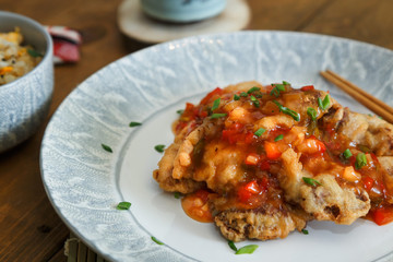 Sweet and sour chicken with rice on a plate
