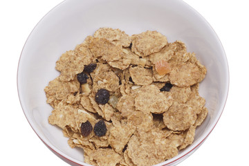 Muesli with raisins on the plate. Isolated