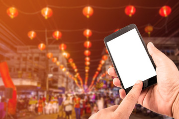 Man hand hold blank touch screen smart phone in china town.