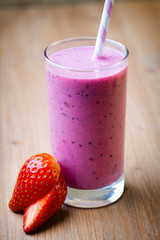 Smoothie, pink juice on the grey  background.