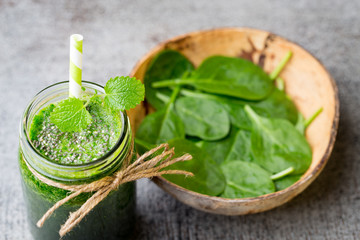 Spinach smoothie, on the grey  background.