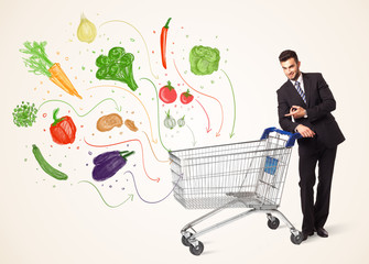 Businessman with shopping cart with vegetables