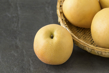 Asian Pears with a bamboo tray on the slate background
