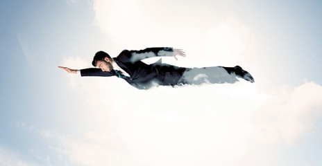 Business man flying like a superhero in clouds on the sky