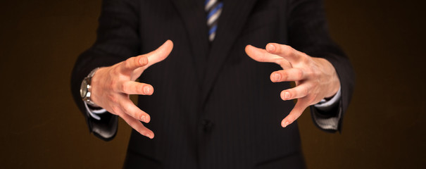 Obraz premium Businessman holding something