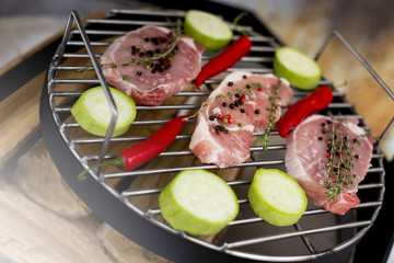 Grilling raw meat on barbecue grill