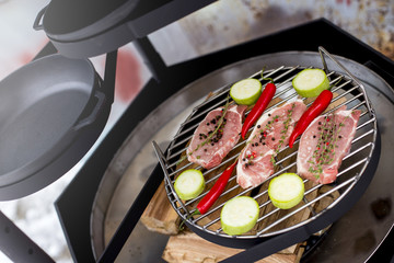 raw meat on the grill with the barbecue zucchini and red pepper