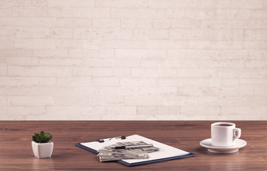 Office desk closeup with white brick wall
