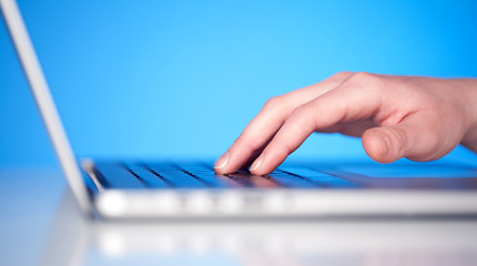 Close up of hand pressing keyboard buttons