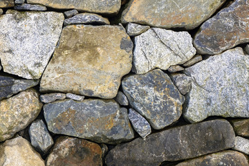 Granite stone wall with colorful stones