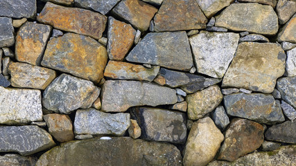 Granite stone wall with colorful stones