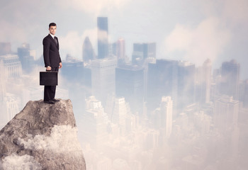 Winner urban businessman on top of stone