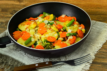 Steamed vegetables potatoes, carrots, corn, green beans and onio