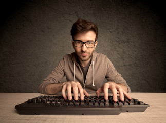 Computer geek typing on keyboard