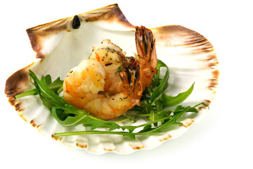 roasted black tiger prawns on rocket salad served in a scallop s