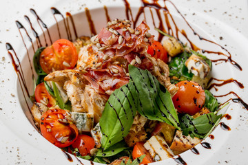 Tasty grilled chicken salad with rucola, cherry tomatoes, valeri