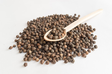 Black pepper and wooden spoon