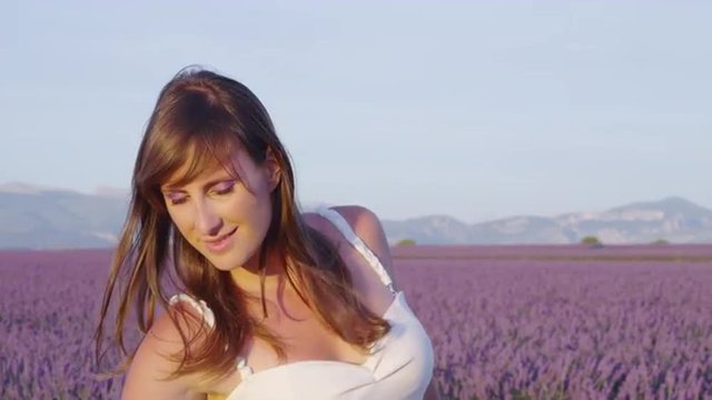 SLOW MOTION: Young woman enjoying in beautiful lavender field