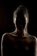 Fototapeta na wymiar silhouette of a unknown woman on a dark background