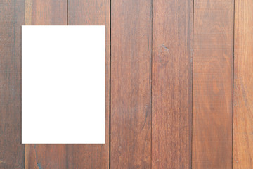 Blank folded paper poster hanging on wooden wall,Template mock up for adding your design.