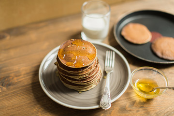 Delicious pancakes close up, with honey