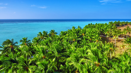 Shoreline of a tropical island in the Maldives and view of the I