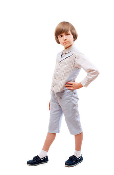 Young boy in light blue suit with waistcoat, isolated on white background