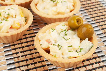 Tartlets with crab salad and olives