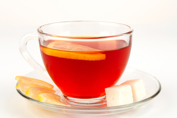 Glass bowl full of tea with pieces of white sugar