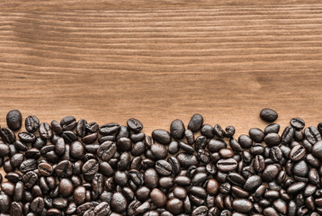 background of brown coffee beans on wood board