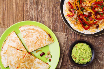 Quesadilla with chicken, served with guacamole or salsa sauce.