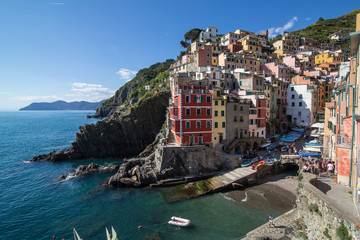 Fototapeta na wymiar View of colorful houses and the harbor in Riomaggiore, Cinque Terre, Liguria, Italy (May 4, 2014)