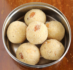 Indian sweet rava laddu, made from rava or semolina, is a delicious and traditional and popular dish, in  a steel box.