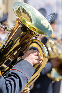 closeup view of brass tuba in hands of musician