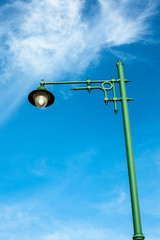 Street lamps aligned with blue sky background.