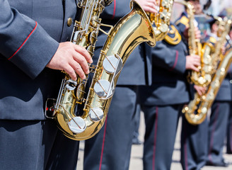 military brass band musicians with gold saxophones