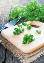 Parsley on wood cutting board.