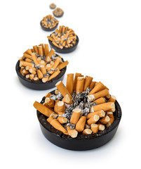 Curve ashtrays full of cigarette butts on a white background